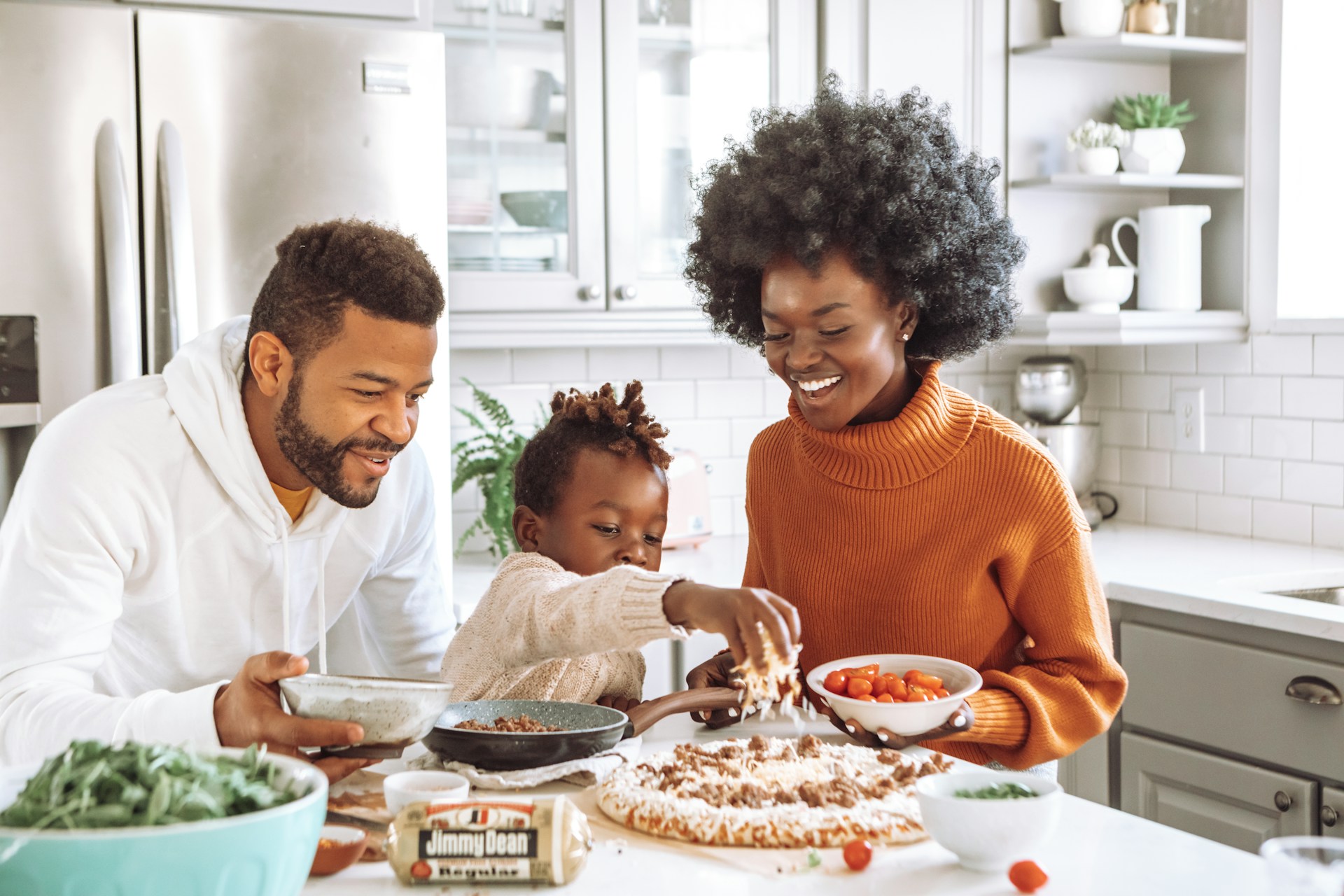 A family cooking together in a bright kitchen